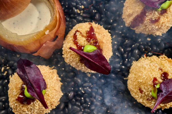 Potato and cheese croquettes with tongue, chicken hearts, veal cheeks and porcini, served with onion-truffle sauce and teriyaki