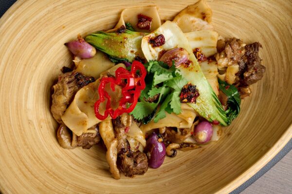 Homemade noodles with braised lamb and Sichuan sauce